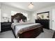 Elegant bedroom with a dark wood bed, crystal chandelier, and neutral décor at 4492 Rita Dr, Las Vegas, NV 89121