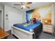 Bright bedroom with a basketball mural, ceiling fan, and a cozy bed at 4492 Rita Dr, Las Vegas, NV 89121
