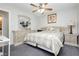 Spacious bedroom with neutral tones, patterned bedding, ceiling fan, and matching dresser and nightstands at 4492 Rita Dr, Las Vegas, NV 89121