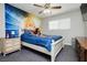 Charming bedroom featuring a basketball mural, ceiling fan, and a cozy bed at 4492 Rita Dr, Las Vegas, NV 89121