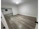 Bright bedroom features wood-look floors, closet with mirrored doors, and neutral paint at 4492 Rita Dr, Las Vegas, NV 89121
