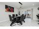 Elegant dining area with modern lighting, stylish table, and sliding door to patio at 4492 Rita Dr, Las Vegas, NV 89121