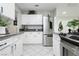 Bright kitchen with white cabinets, stainless steel fridge and light grey countertops at 4492 Rita Dr, Las Vegas, NV 89121