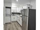 Modern kitchen featuring stainless steel appliances, stacked laundry, and sleek cabinetry at 4492 Rita Dr, Las Vegas, NV 89121