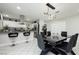 Open kitchen features white cabinets, stainless steel appliances, island with bar seating, and modern lighting at 4492 Rita Dr, Las Vegas, NV 89121