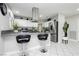 Bright kitchen with stainless steel appliances, white cabinets, and a stylish island with bar stools at 4492 Rita Dr, Las Vegas, NV 89121
