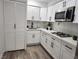 Beautiful kitchen with white cabinets, stainless steel appliances, and modern black hardware at 4492 Rita Dr, Las Vegas, NV 89121