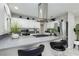 Modern kitchen features stainless steel appliances, white cabinets, and an island with seating at 4492 Rita Dr, Las Vegas, NV 89121