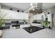 Contemporary kitchen with stainless steel appliances, gray countertops and sleek modern vent hood at 4492 Rita Dr, Las Vegas, NV 89121