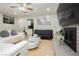 Inviting living room with contemporary furniture, a fireplace, and natural light at 4492 Rita Dr, Las Vegas, NV 89121