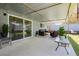 Inviting covered patio with outdoor seating, creating a cozy space for relaxation and entertaining guests at 4492 Rita Dr, Las Vegas, NV 89121