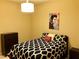 A cozy bedroom features a black and white patterned bedspread with an Elvis Presley portrait at 4575 Dean Martin Dr # 303, Las Vegas, NV 89103