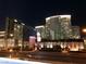 Night shot of a city skyline featuring modern buildings and brightly lit streets at 4575 Dean Martin Dr # 303, Las Vegas, NV 89103