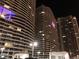 Exterior night view of modern high rise buildings with illuminated windows and balconies at 4575 Dean Martin Dr # 303, Las Vegas, NV 89103