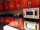 Spacious kitchen with ample cherry wood cabinetry, stainless steel appliances, and tile backsplash at 4575 Dean Martin Dr # 303, Las Vegas, NV 89103
