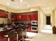 Spacious kitchen with breakfast bar, cherry cabinetry, and stainless steel appliances at 4575 Dean Martin Dr # 303, Las Vegas, NV 89103