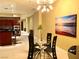 Open-concept space featuring a kitchen with dark wood cabinets and a glass dining table at 4575 Dean Martin Dr # 303, Las Vegas, NV 89103