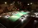 Aerial view of a shared pool with decorative lighting between modern residential buildings at night at 4575 Dean Martin Dr # 303, Las Vegas, NV 89103