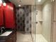 Bathroom featuring a glass shower enclosure, modern vanity, and wallpaper accent wall at 4575 Dean Martin Dr # 705, Las Vegas, NV 89103