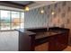 Open kitchenette featuring granite countertops, modern sink fixtures, stainless steel appliances, and a city view at 4575 Dean Martin Dr # 705, Las Vegas, NV 89103