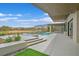 Back exterior showcasing a pool, outdoor kitchen, and picturesque views of a golf course at 49 Crested Cloud Way, Las Vegas, NV 89135