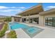 Back exterior showcasing a pool, spa, outdoor kitchen, and sliding glass doors at 49 Crested Cloud Way, Las Vegas, NV 89135