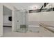 Modern bathroom with glass-enclosed shower, luxurious tub, and sleek vanity at 49 Crested Cloud Way, Las Vegas, NV 89135
