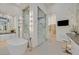 Elegant bathroom boasting soaking tub, glass shower, and chic vanity with comfortable seating at 49 Crested Cloud Way, Las Vegas, NV 89135