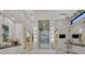 Lavish bathroom featuring marble accents, soaking tub, glass shower, and vanity with makeup area at 49 Crested Cloud Way, Las Vegas, NV 89135