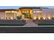Modern home featuring landscape lighting, desert landscaping, and a gated entry at 49 Crested Cloud Way, Las Vegas, NV 89135