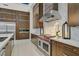 Elegant kitchen featuring professional-grade appliances, custom cabinetry, and marble backsplash at 49 Crested Cloud Way, Las Vegas, NV 89135