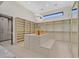 Well-organized walk-in closet with extensive shelving, drawers, seating, and contemporary lighting at 49 Crested Cloud Way, Las Vegas, NV 89135