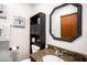 Bathroom vanity with granite countertop, octagonal mirror, and cabinet at 4955 Jeffreys St # 605, Las Vegas, NV 89119