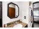 Bathroom featuring granite countertop vanity, mirror, and in unit laundry machines at 4955 Jeffreys St # 605, Las Vegas, NV 89119