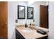 Spacious bathroom with granite countertop, dual mirrors, and dark cabinets at 4955 Jeffreys St # 605, Las Vegas, NV 89119
