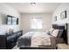 Comfortable bedroom featuring dark wood dresser and headboard with bright window at 4955 Jeffreys St # 605, Las Vegas, NV 89119
