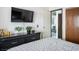 Cozy bedroom with TV, dark dresser, and inviting bed with patterned bedding at 4955 Jeffreys St # 605, Las Vegas, NV 89119