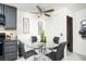 Modern dining area boasts a glass-top table, stylish black chairs, and kitchen appliances at 4955 Jeffreys St # 605, Las Vegas, NV 89119
