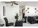 Dining area featuring a glass-top table with black chairs and a black leather sofa in the background at 4955 Jeffreys St # 605, Las Vegas, NV 89119