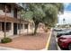 Two-story apartment building with red rock landscaping, mature olive trees, and parking in front at 4955 Jeffreys St # 605, Las Vegas, NV 89119