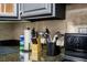 Kitchen area featuring granite countertop with neutral backsplash and dark cabinets at 4955 Jeffreys St # 605, Las Vegas, NV 89119