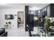 Open-concept living room with modern gray kitchen, glass dining table, and view into the bedroom at 4955 Jeffreys St # 605, Las Vegas, NV 89119