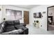 Cozy living room featuring a modern black sectional sofa, TV, and a doorway to the bedroom at 4955 Jeffreys St # 605, Las Vegas, NV 89119