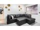 Stylish living room with a black sectional sofa, decorative wall art, and natural light at 4955 Jeffreys St # 605, Las Vegas, NV 89119