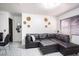 Modern living room boasts a sleek black leather sectional sofa and decorative wall art at 4955 Jeffreys St # 605, Las Vegas, NV 89119