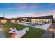A fully landscaped backyard features a pool, bar, and putting green perfect for outdoor fun and relaxation at 5081 Notting Hill Ave, Las Vegas, NV 89139