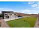Backyard boasts a pool, putting green, spa, built-in kitchen, lounge spaces, and well-maintained landscaping at 5081 Notting Hill Ave, Las Vegas, NV 89139