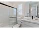 Bright bathroom featuring a glass-enclosed shower, white vanity, and modern fixtures at 5081 Notting Hill Ave, Las Vegas, NV 89139