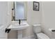 Modern powder room featuring a pedestal sink, black fixtures, and decorative artwork at 5081 Notting Hill Ave, Las Vegas, NV 89139