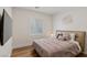 Bright bedroom with a cozy bed, window shutters, and a mounted TV at 5081 Notting Hill Ave, Las Vegas, NV 89139